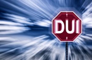 Blurred image of a sign that reads DUI.