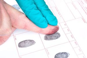 Fingers being fingerprinted.