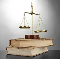 scales of justice on a pair of old books