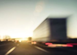 Blurred image of a large truck on the road. 