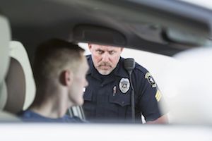 A police officer speaking to a man that he has pulled over. 